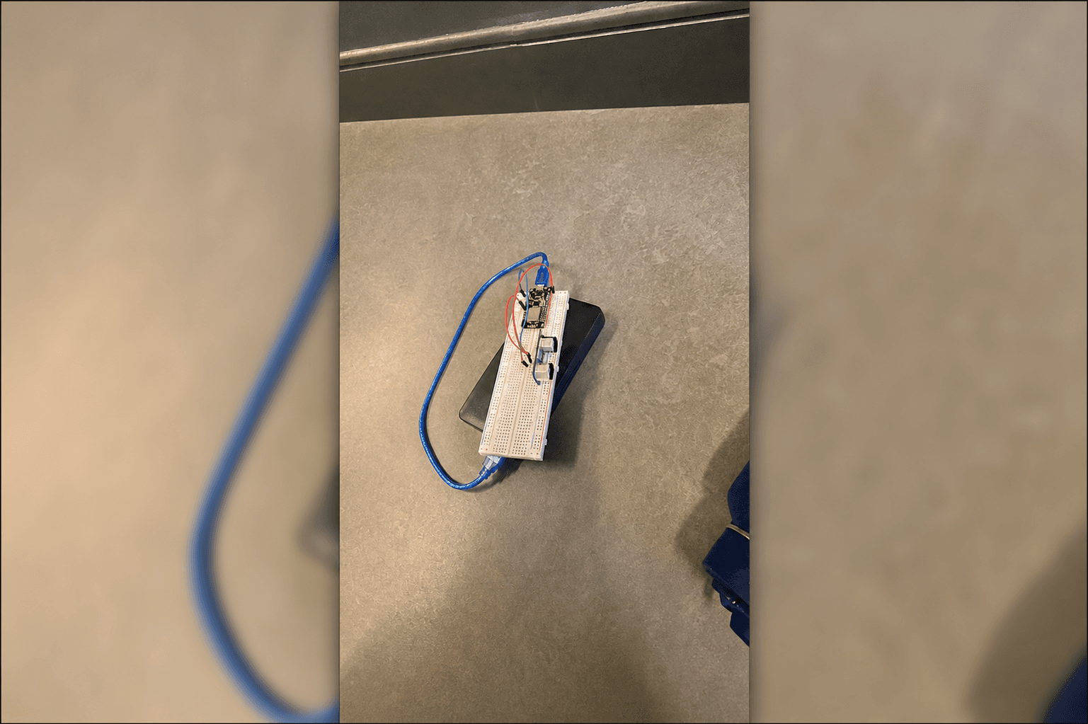 Photo of the AutoAlt prototype with a breadboard, microcontroller, and wiring on a table